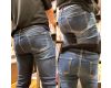 The dark blue denim buttocks of a sober girl