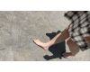 Japanese girl walks barefoot in the hot summer park